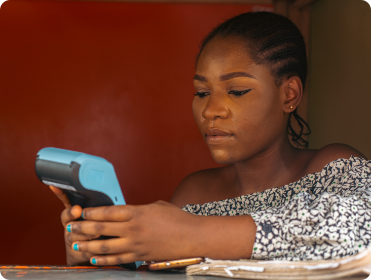 woman holding a pos machine in her hands